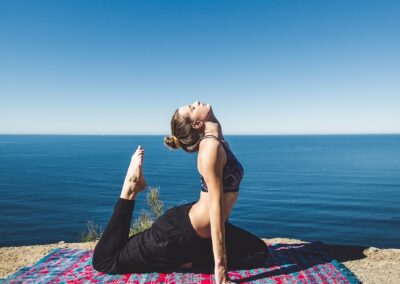 A Woman Practicing Yoga in the Beach